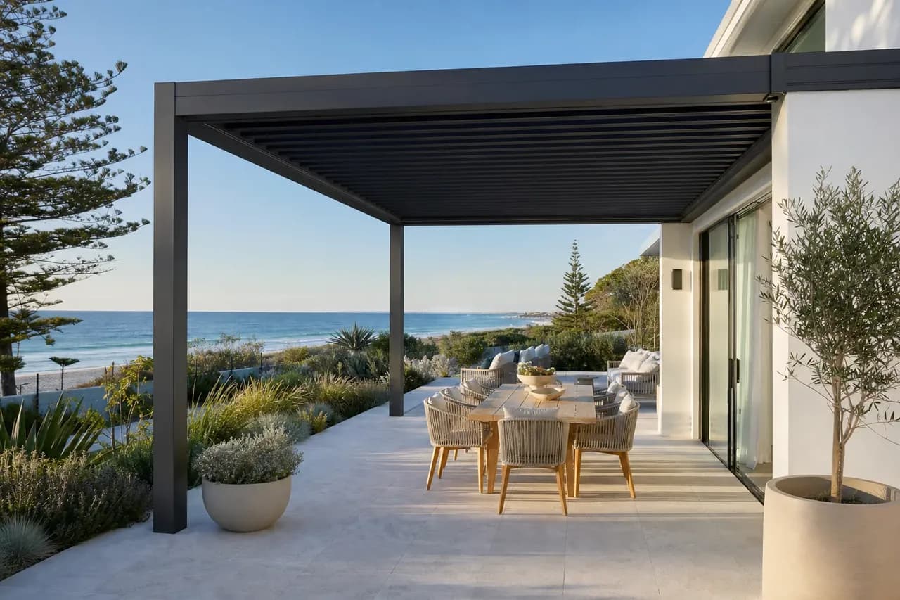 Freestanding steel pergola over a paved alfresco at a Cottesloe beachside home in Perth's western suburbs