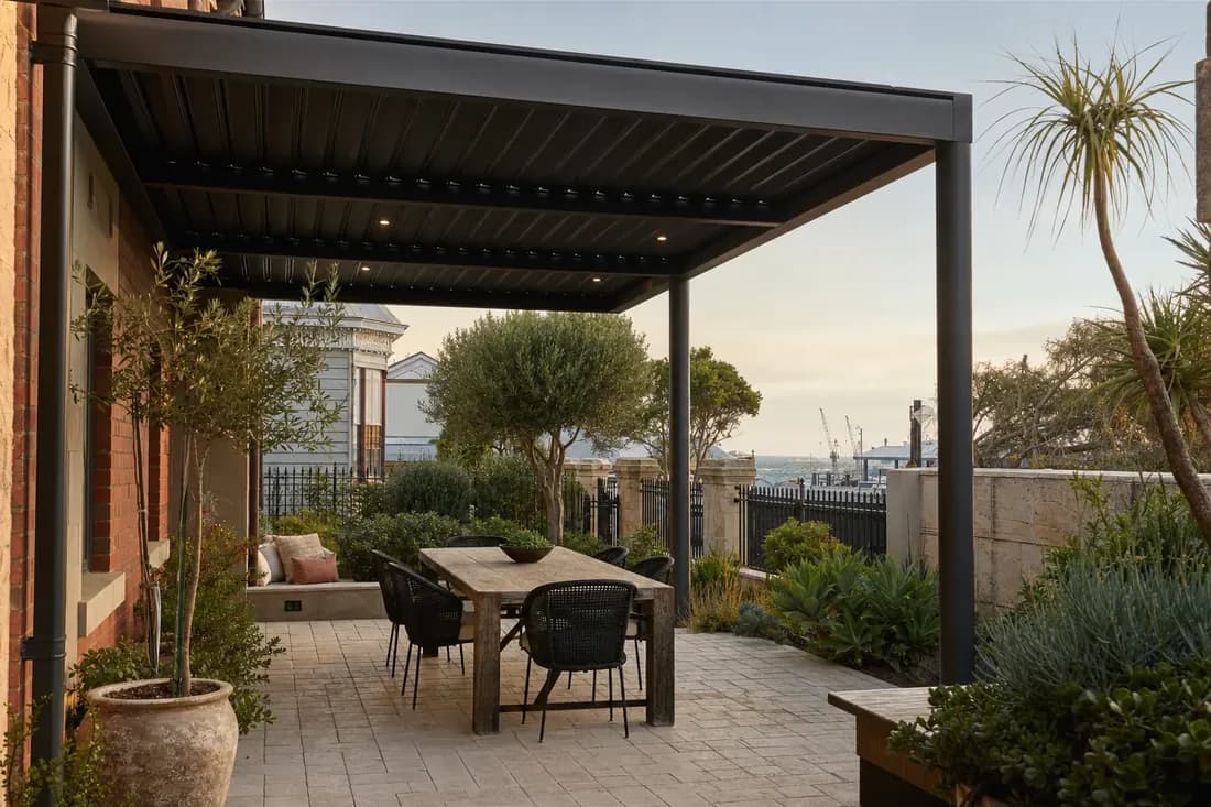 Steel pergola over a paved alfresco at a Fremantle port-city home on Perth's south-west coast