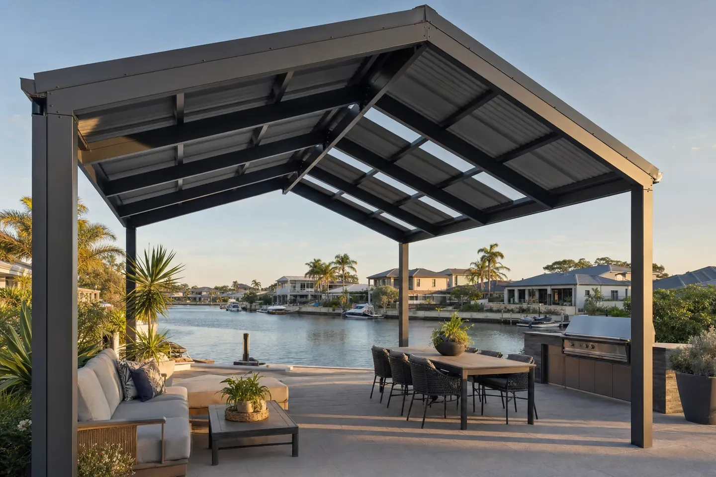Gable steel pergola over a paved alfresco at a canal-side family home in Mandurah
